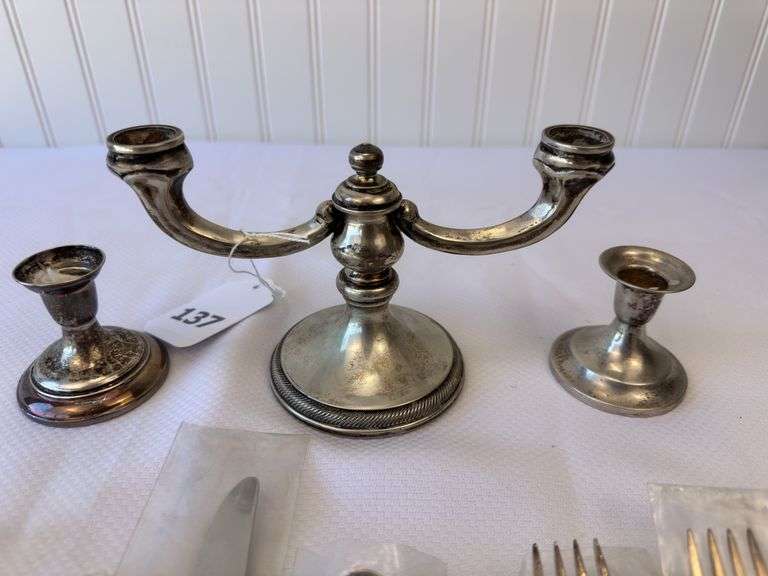 Approximately 11 pieces of Sterling flatware, 3 weighted candlesticks that appear to be sterling.