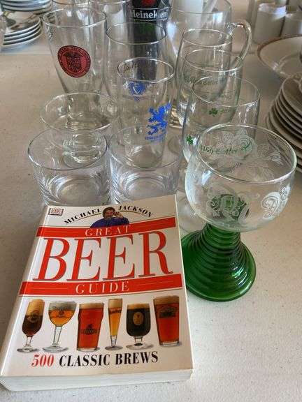 Clear glass pitcher, bar glasses, beer guide book