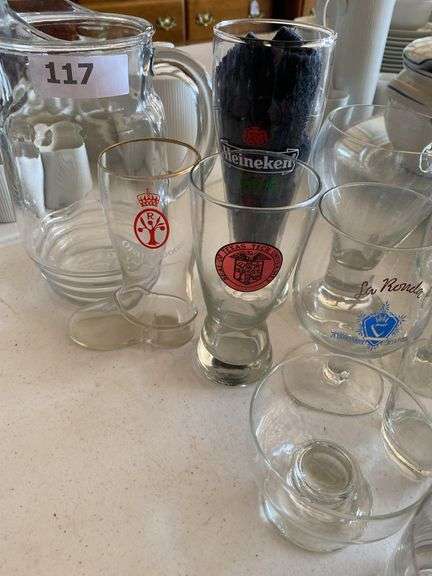 Clear glass pitcher, bar glasses, beer guide book