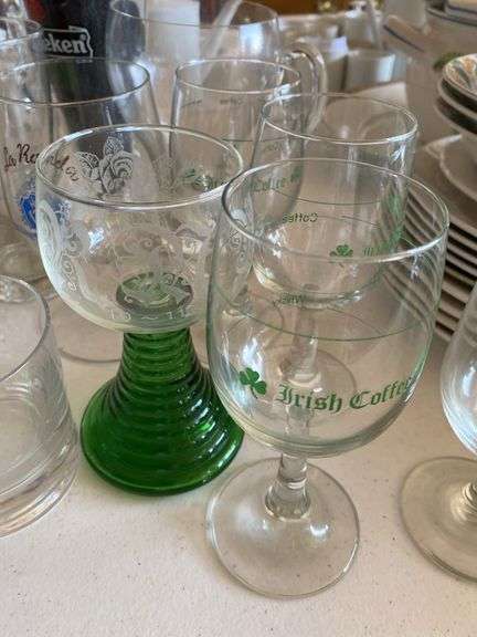 Clear glass pitcher, bar glasses, beer guide book