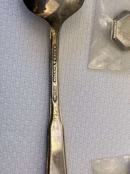 Approximately 11 pieces of Sterling flatware, 3 weighted candlesticks that appear to be sterling.
