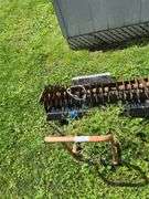 Pull behind lawn aerator on utility dolly