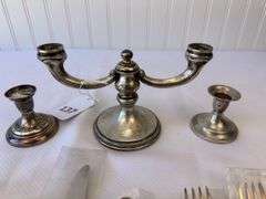 Approximately 11 pieces of Sterling flatware, 3 weighted candlesticks that appear to be sterling.