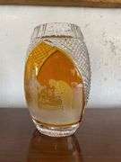 Amber cut to clear golf vase on wood stand