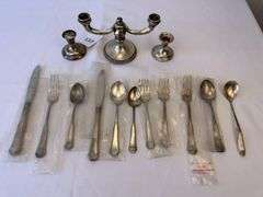 Approximately 11 pieces of Sterling flatware, 3 weighted candlesticks that appear to be sterling.