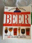 Clear glass pitcher, bar glasses, beer guide book