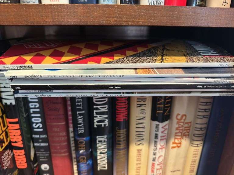 Bottom 2 shelves of hard back and paperback books