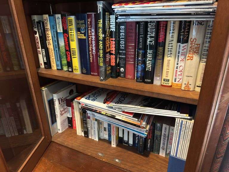 Bottom 2 shelves of hard back and paperback books