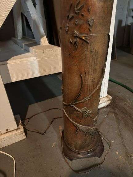 40”h  lamp with sculpture details in basement without shade
