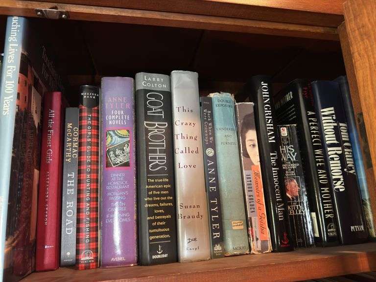 Top shelf of hardback and paperback books