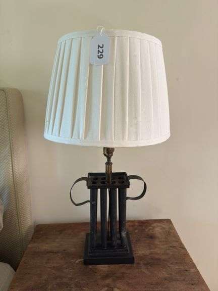 29” black lamp with shade. Base is wood and metal. Does have dent