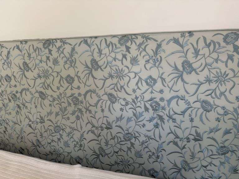 Full size bed with bedding. Upholstered headboard