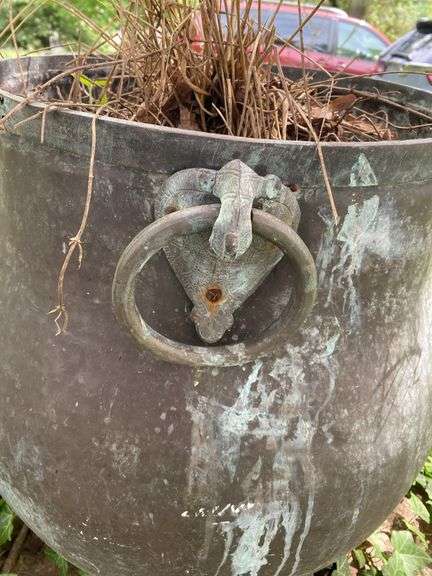 Very heavy cast iron pot with brass ring handles, 20”d x 24”h, (heavy items, must have your own help to load)