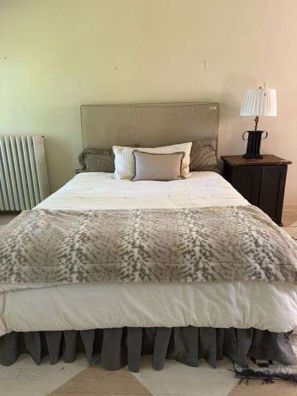 Queen size bed with bedding. Upholstered headboard