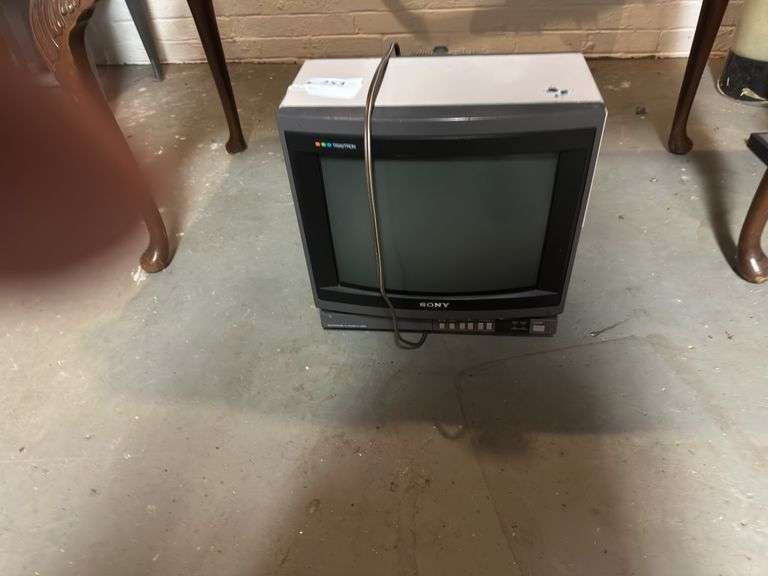 Old Sony tv, floor lamp, Yamaha stereo cassette deck, DVDs,  Panasonic movie camera, & canon movie camera. In basement image