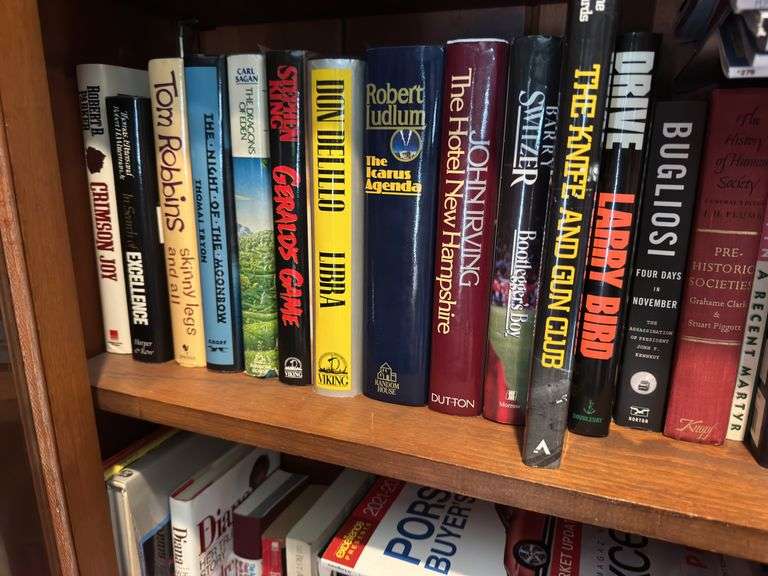 Bottom 2 shelves of hard back and paperback books