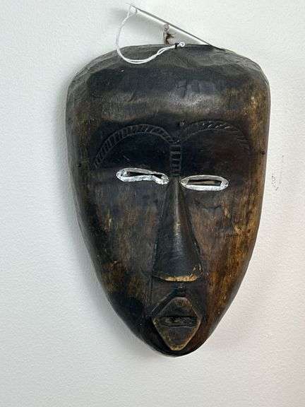 Collection of Hand-Carved Tribal Masks and Woven Wall Basket image