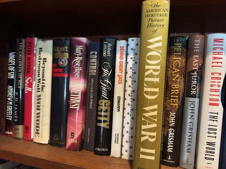 Top 2 shelves of hardback and paper back books