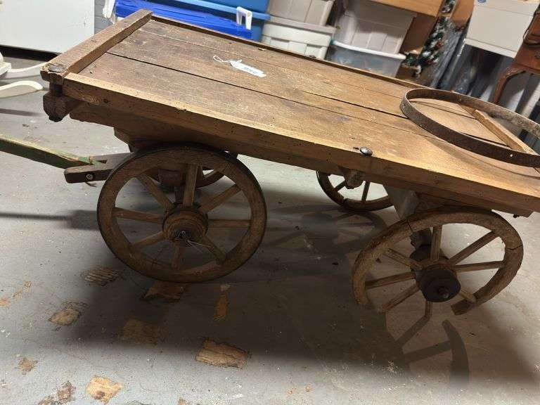 Antique Flatbed wagon with broken wheel  in basement