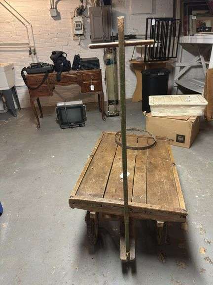 Antique Flatbed wagon with broken wheel  in basement