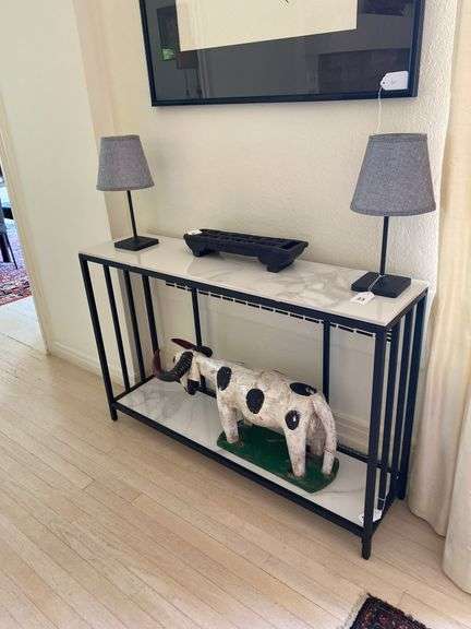 Metal framed entry table with marble top and bottom shelf 47”w x 12”d x 31”t, excludes all contents image