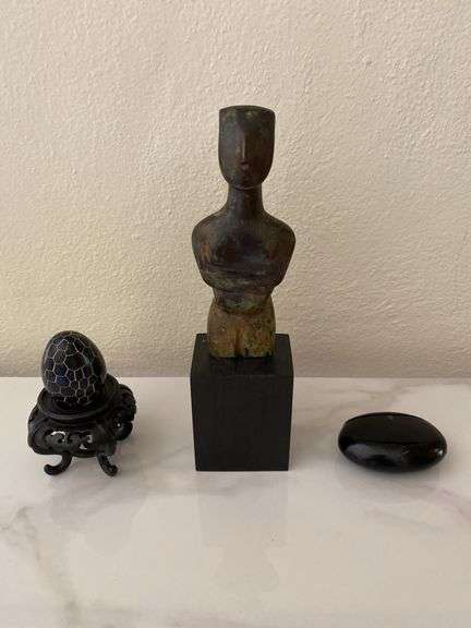 Stone carved figurine on wood base, lidded seed pod, etched egg on wood base image