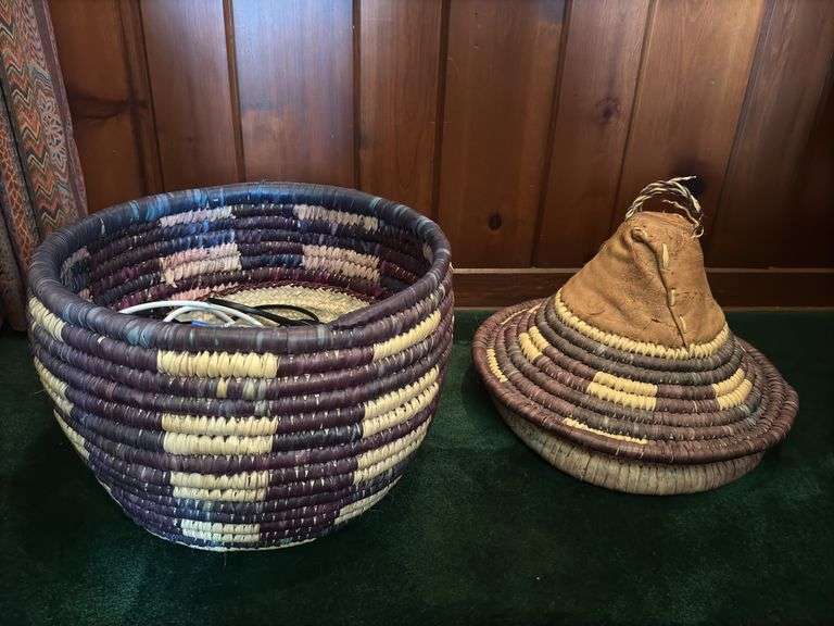 Hand woven basket with a conical leather lid 22” tall