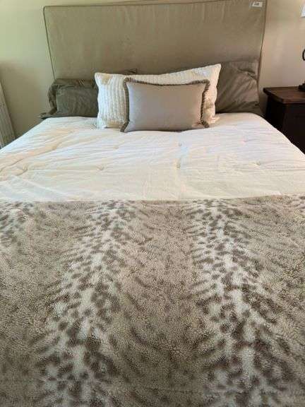 Queen size bed with bedding. Upholstered headboard