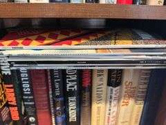 Bottom 2 shelves of hard back and paperback books