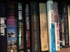 Top shelf of hardback and paperback books