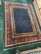 Hand knotted wool rug (missing some edging) 58” x 77”
