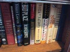 Bottom 2 shelves of hard back and paperback books