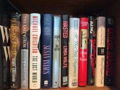 Top 2 shelves of hardback and paper back books