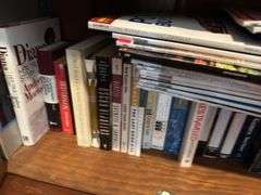 Bottom 2 shelves of hard back and paperback books