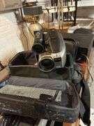 Old Sony tv, floor lamp, Yamaha stereo cassette deck, DVDs,  Panasonic movie camera, & canon movie camera. In basement