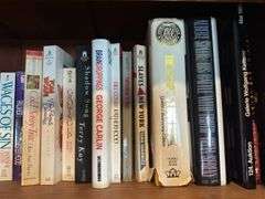 Top 2 shelves of hardback and paper back books