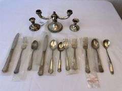 Approximately 11 pieces of Sterling flatware, 3 weighted candlesticks that appear to be sterling.