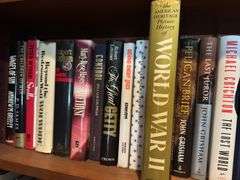 Top 2 shelves of hardback and paper back books