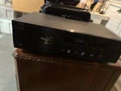 Old Sony tv, floor lamp, Yamaha stereo cassette deck, DVDs,  Panasonic movie camera, & canon movie camera. In basement