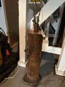 40”h  lamp with sculpture details in basement without shade