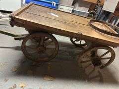 Antique Flatbed wagon with broken wheel  in basement