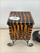 Decorative box on wire base, candle with base, black photo frames, books