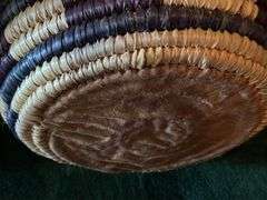 Hand woven basket with a conical leather lid 22” tall