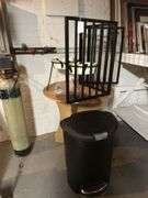 Step trash can, gate, round table, pair of tall dog dishes. In basement