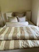 Full size upholstered ivory silk bed and bedding