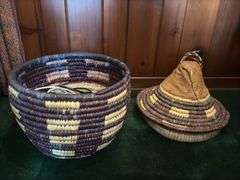 Hand woven basket with a conical leather lid 22” tall