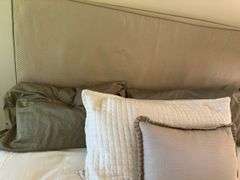 Queen size bed with bedding. Upholstered headboard