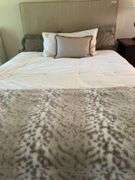 Queen size bed with bedding. Upholstered headboard