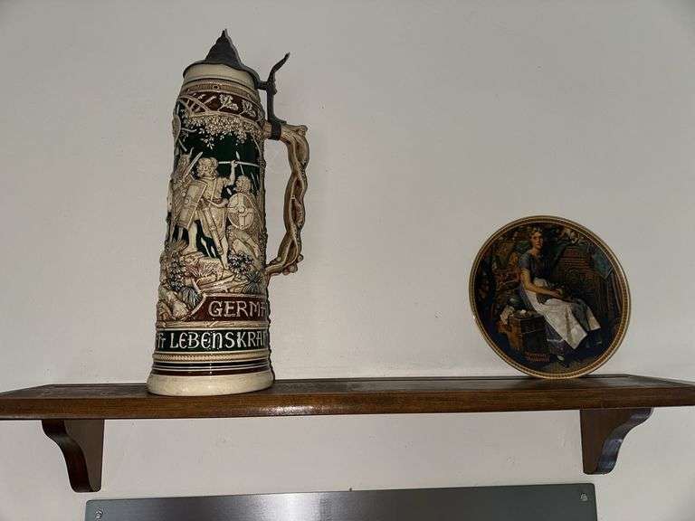 Beer tanker with lid 17”height decorative handle with warrior scenes on body of Stein Condition is very good With pewter lid, collector plate, shelf image