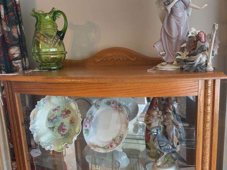 Oak lighted display case with curved glass front, mirrored back, glass shelves 33" x 59" x 15"
